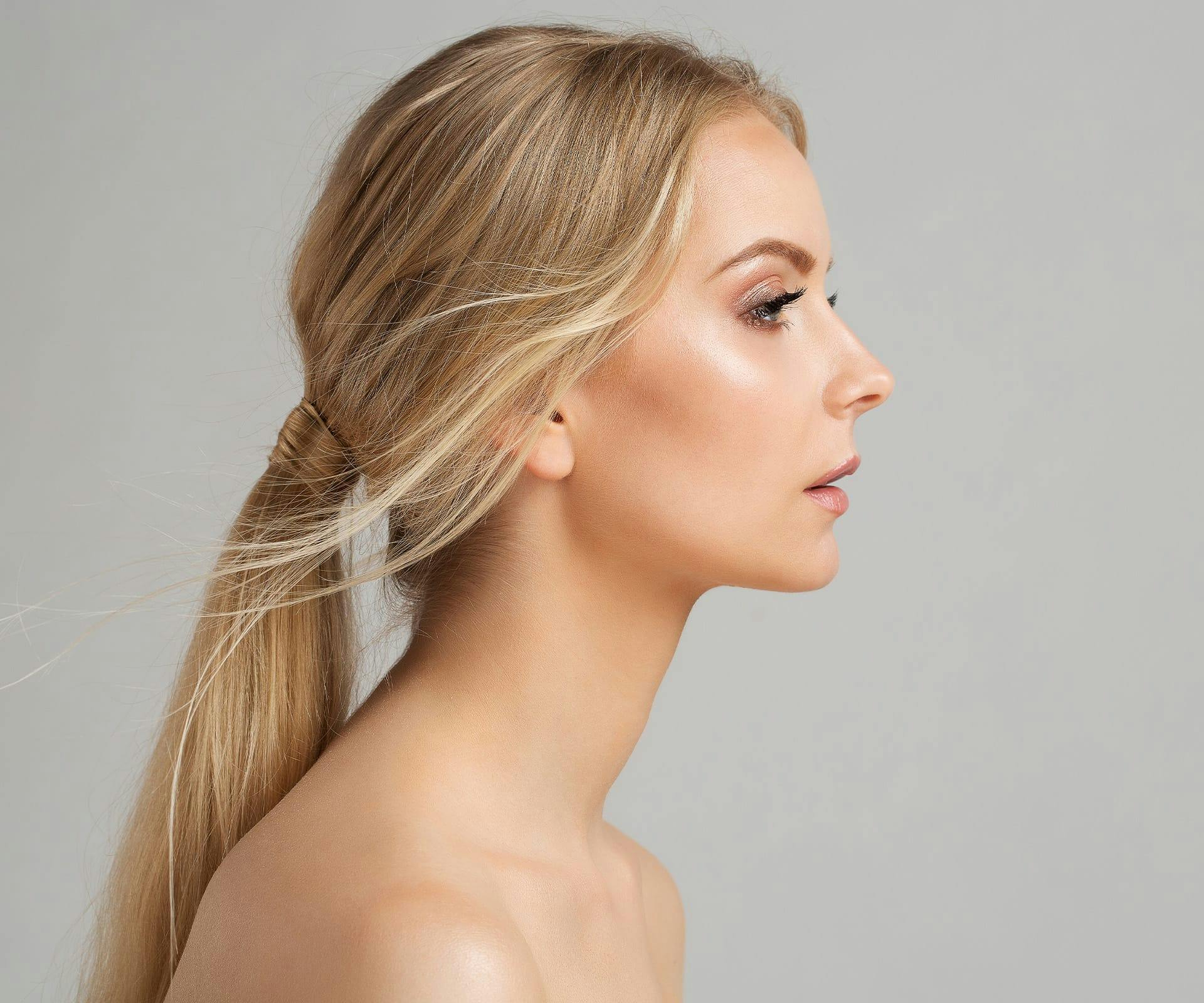 woman side profile with low pony tail