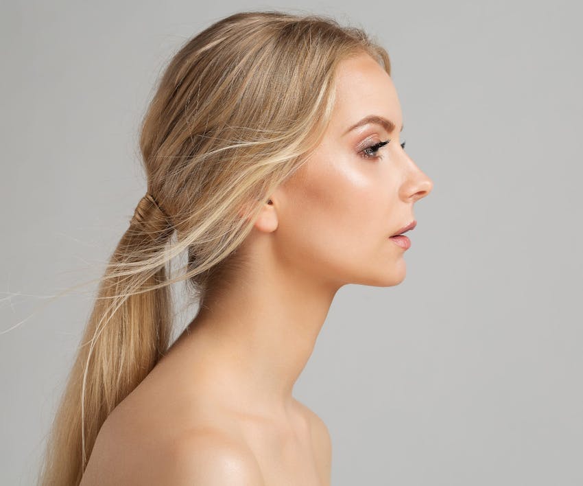 woman side profile with low pony tail