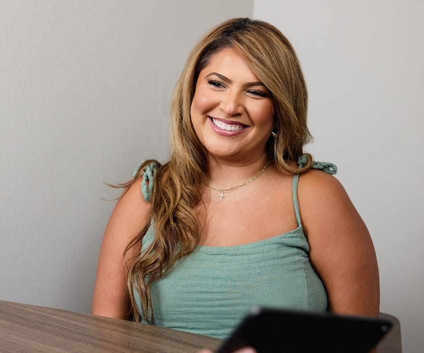 woman in green smiling