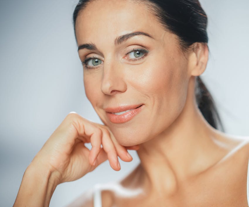 woman resting her chin on her hand