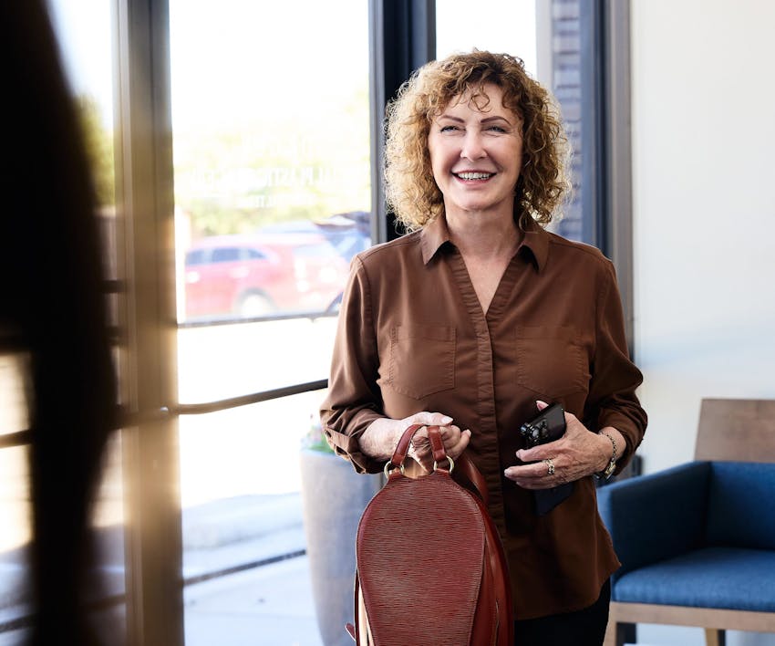 patient holding her bag and smiling