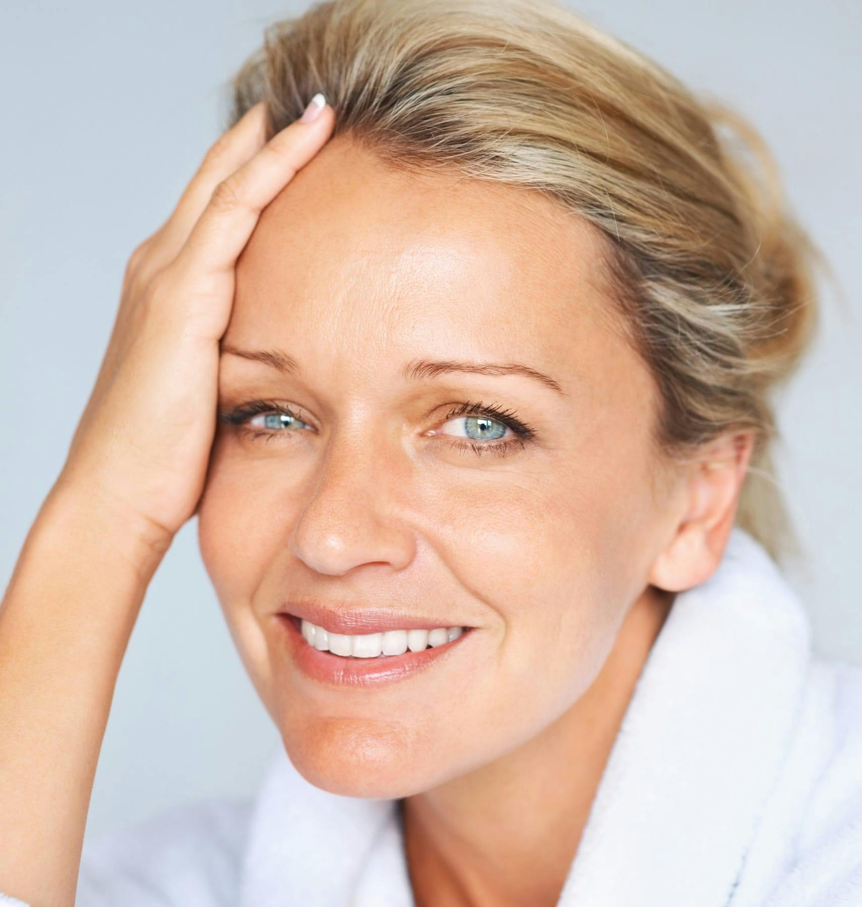 woman with hand combing through her hair