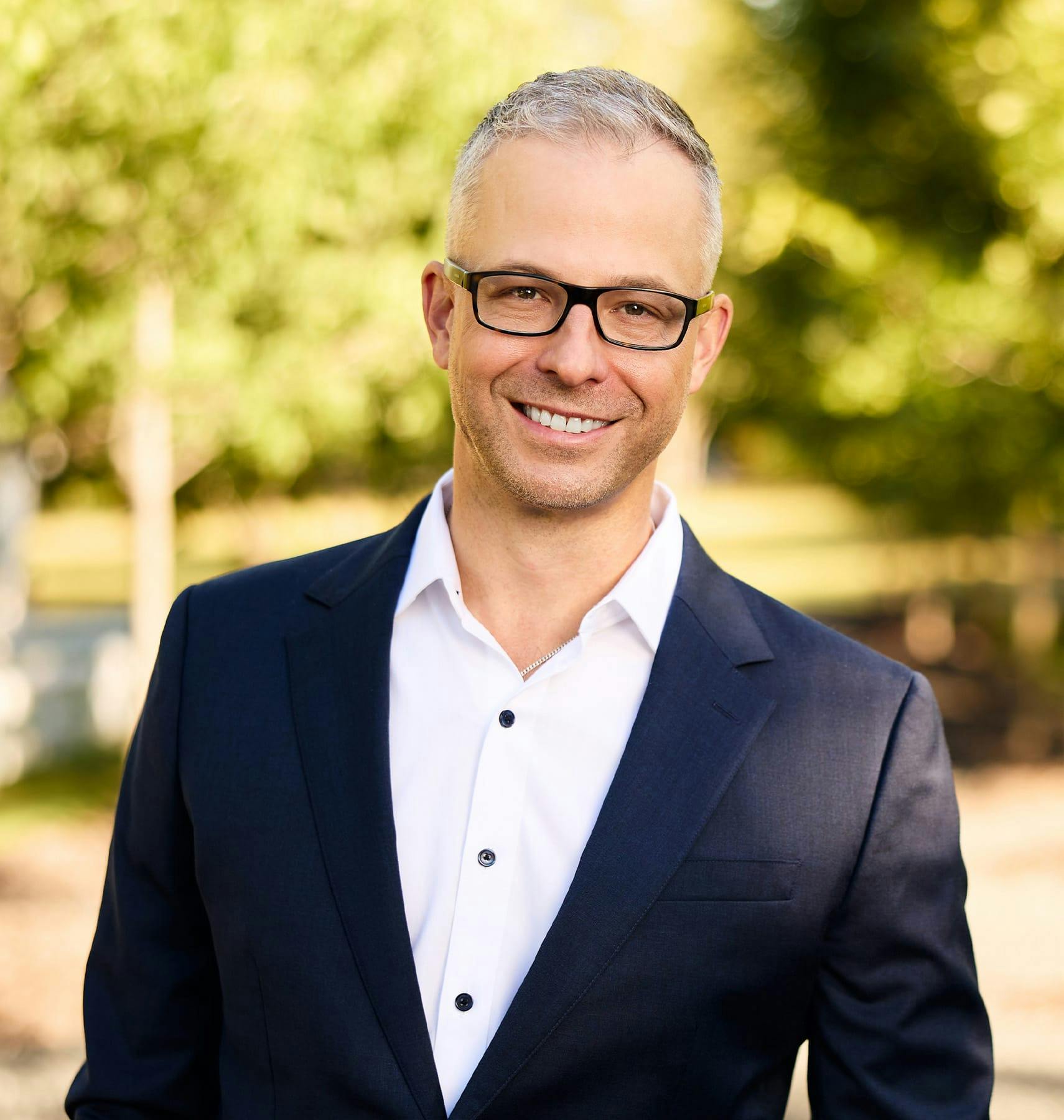 Dr. Guy in suit smiling