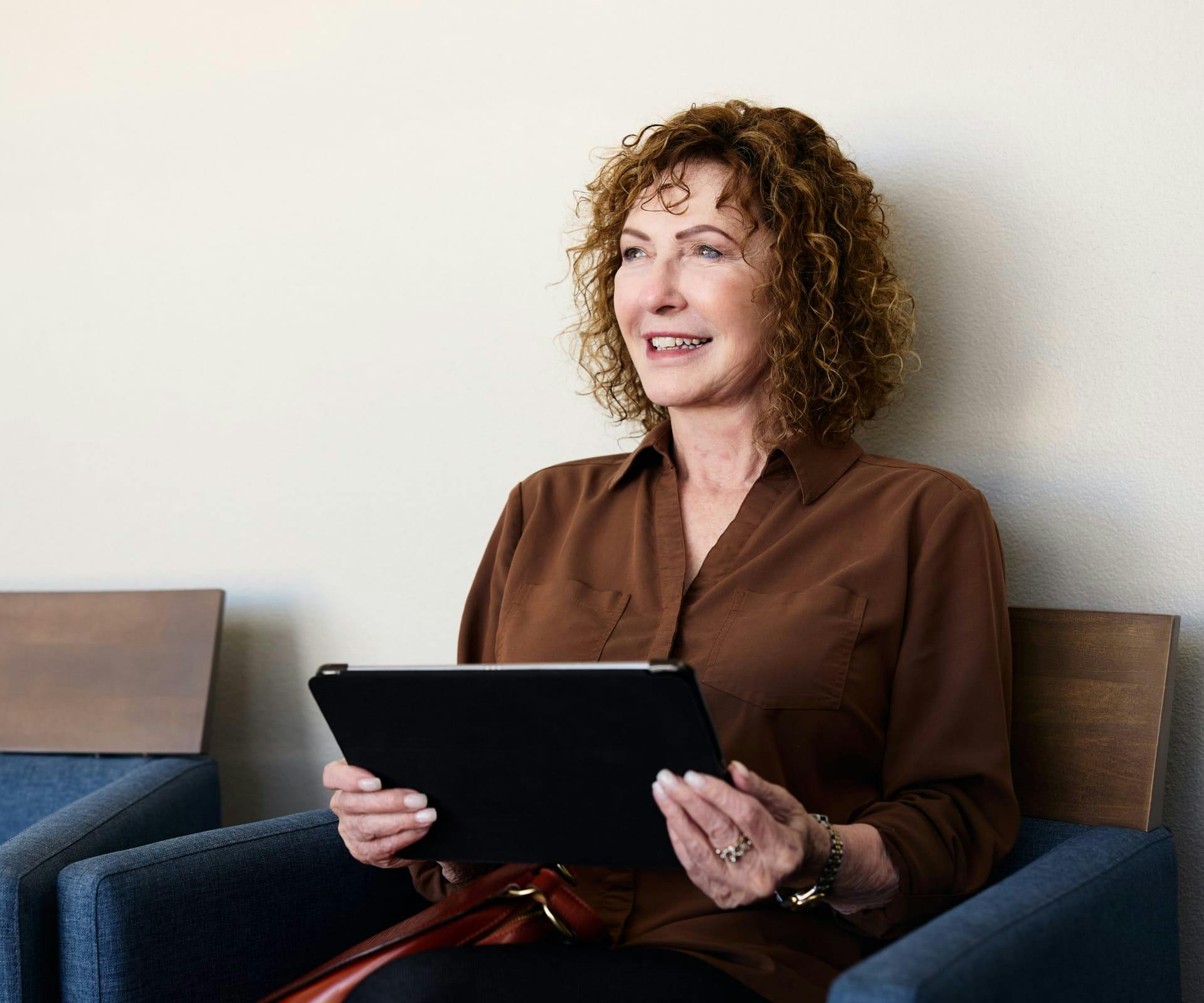 woman holding ipad