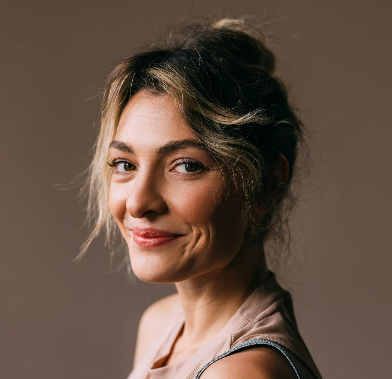 woman smirking with her hair in an updo