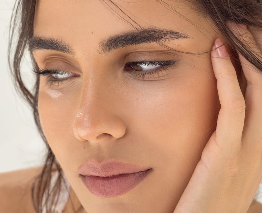 Close-up of woman resting her head in her hand