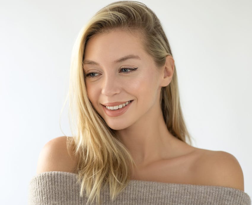 Smiling blonde woman in sweater