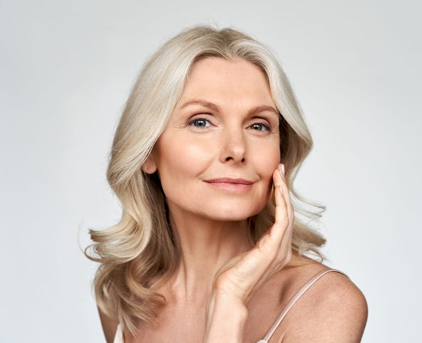 Woman feeling her cheek