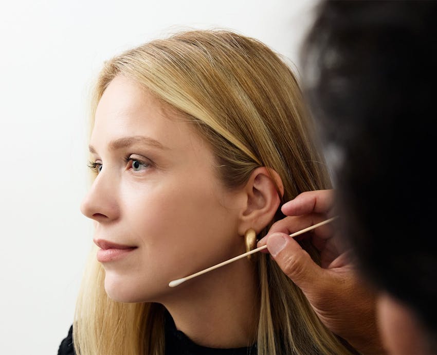 woman with blonde hair looking to the side
