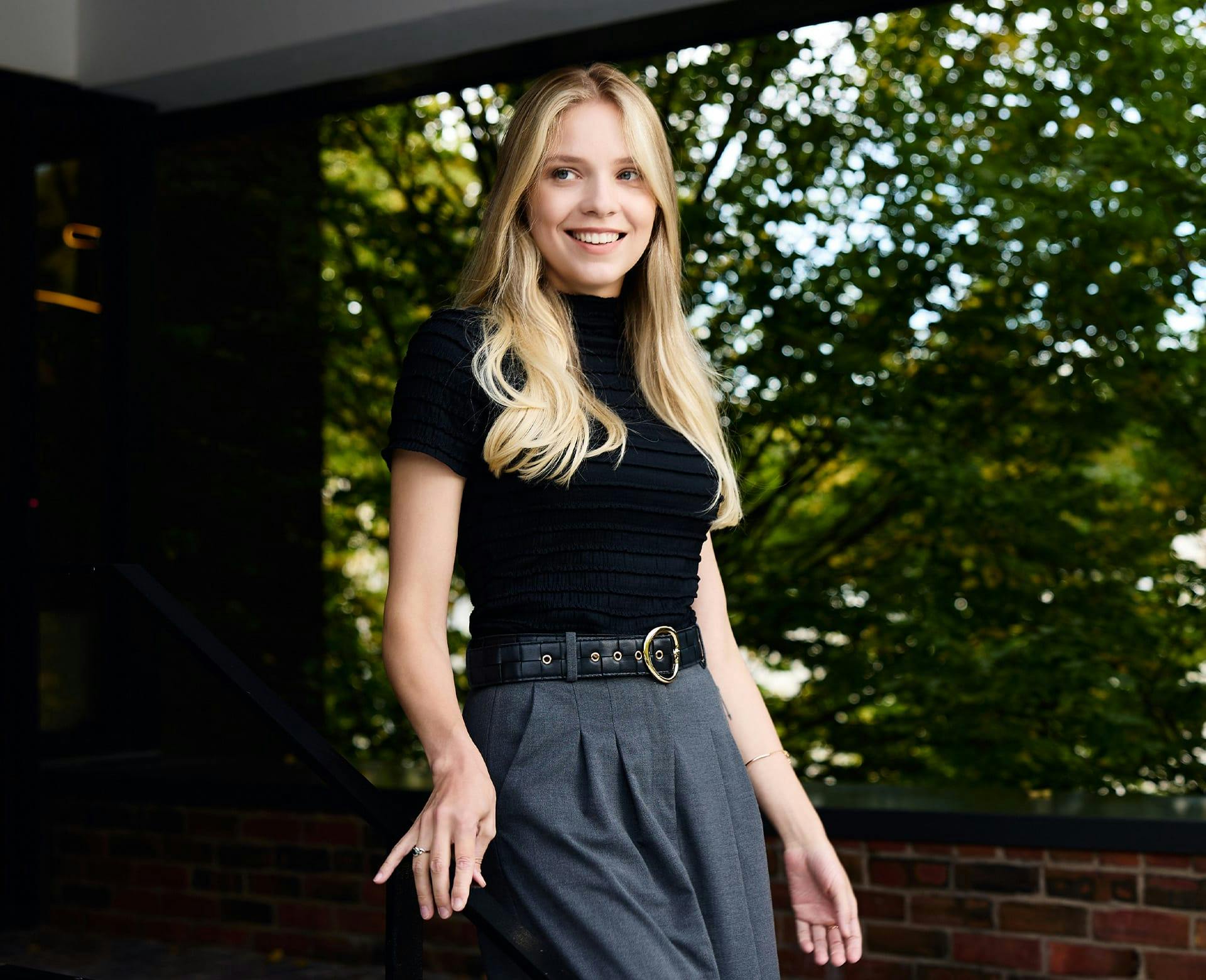 woman in a black shirt and grey pants