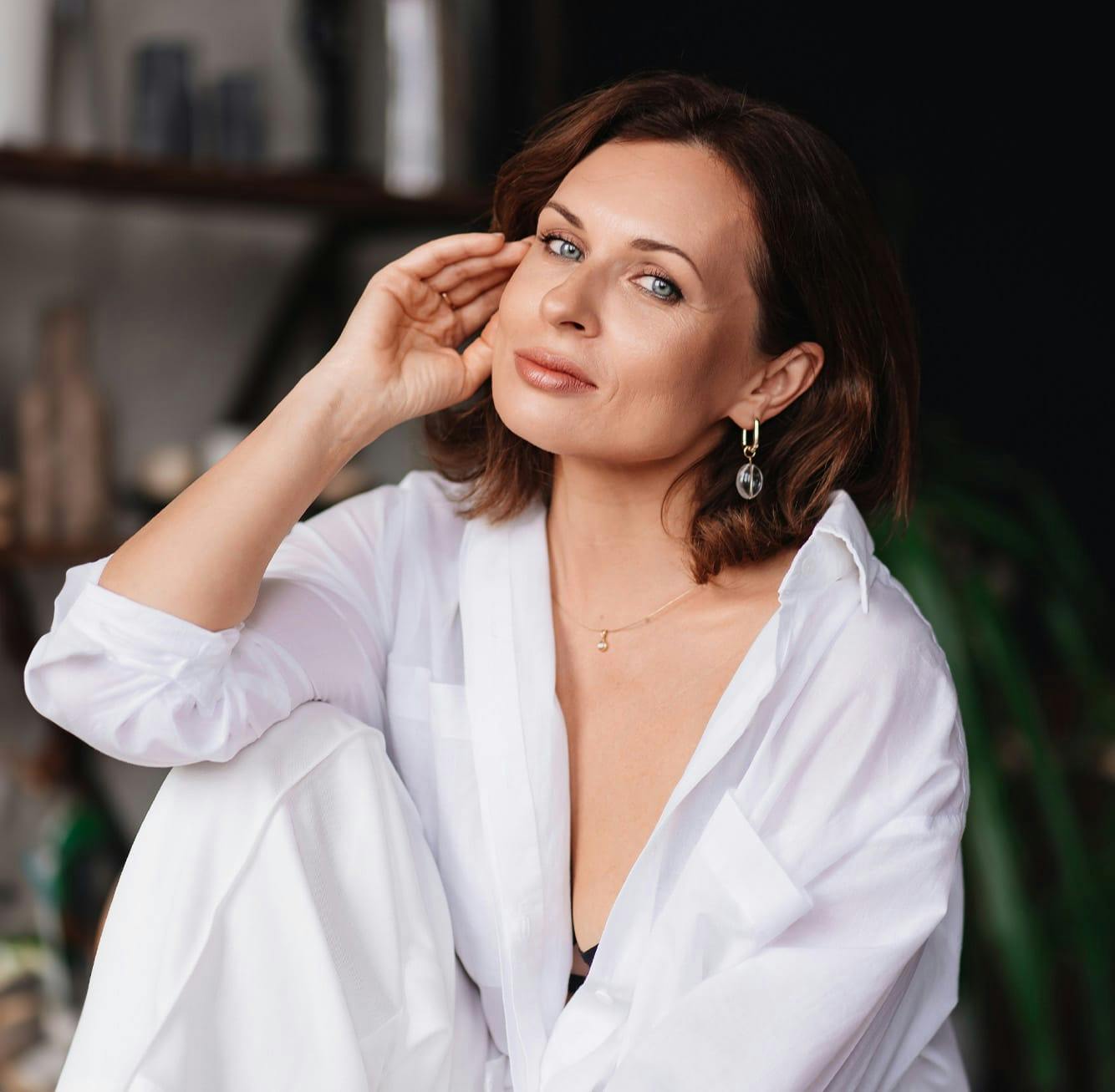 woman in a white button up and pants