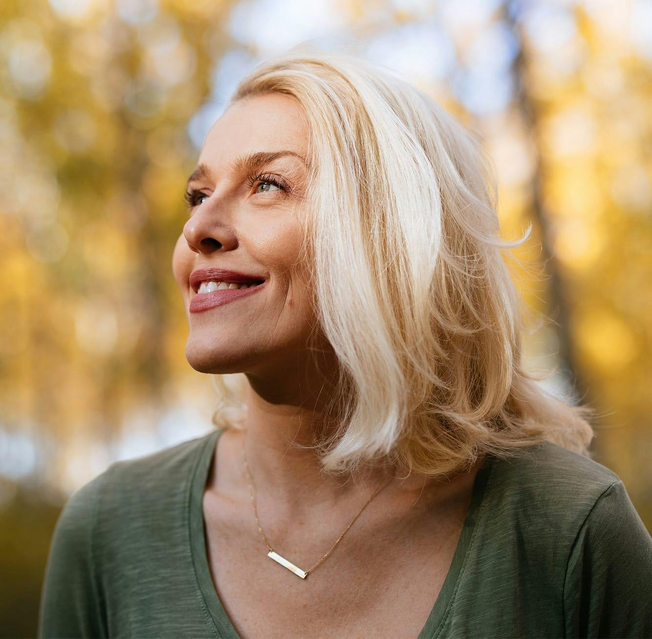 Woman smiling into sunlight
