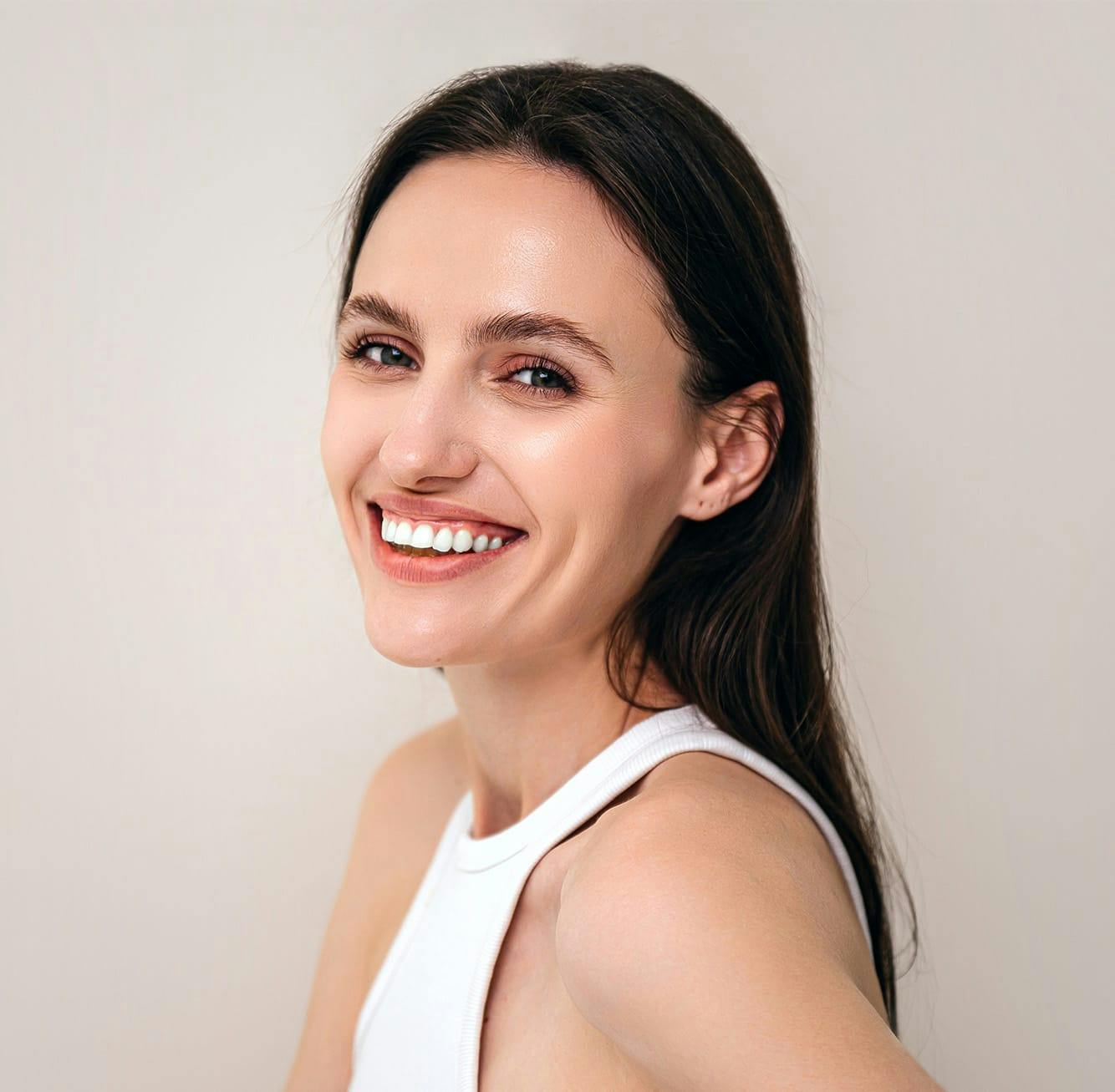 Woman smiling over her shoulder