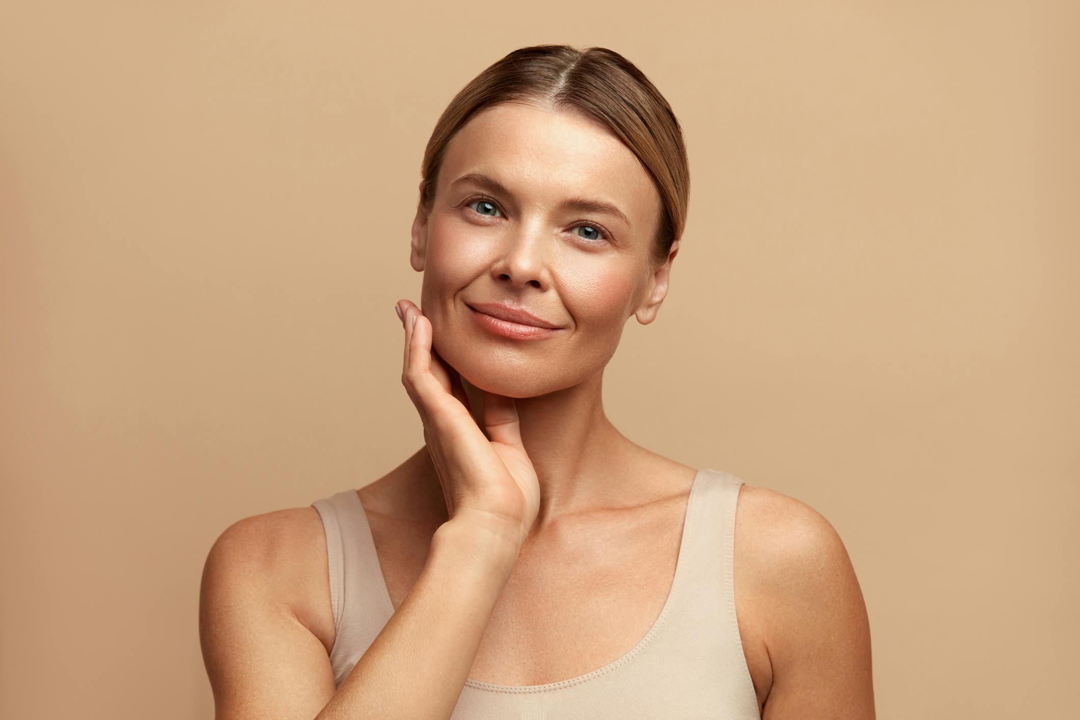 woman with hand on face smiling
