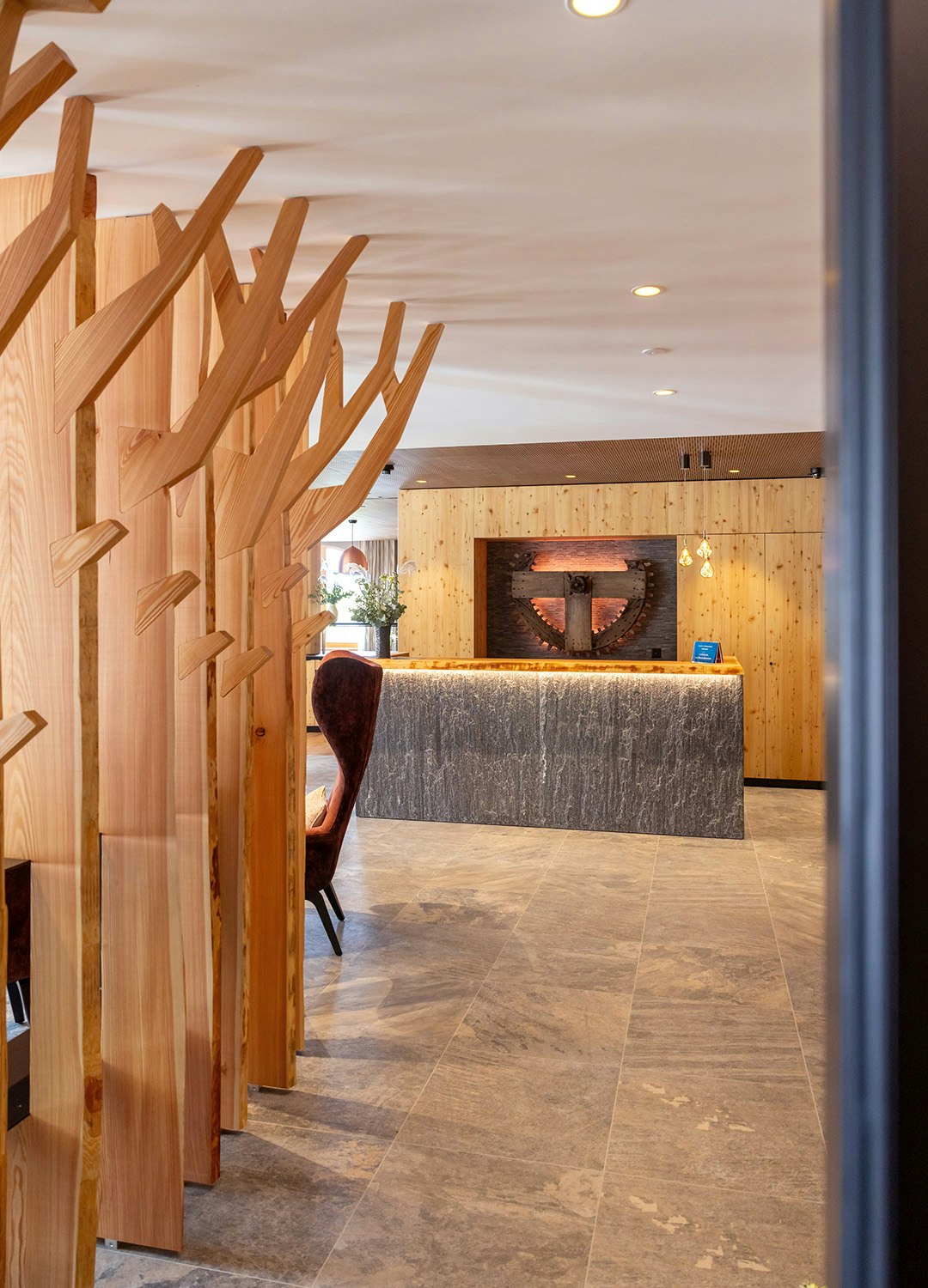 Reception entrance area View of stone reception on the left, wooden cloakroom in the background, old mill wheel