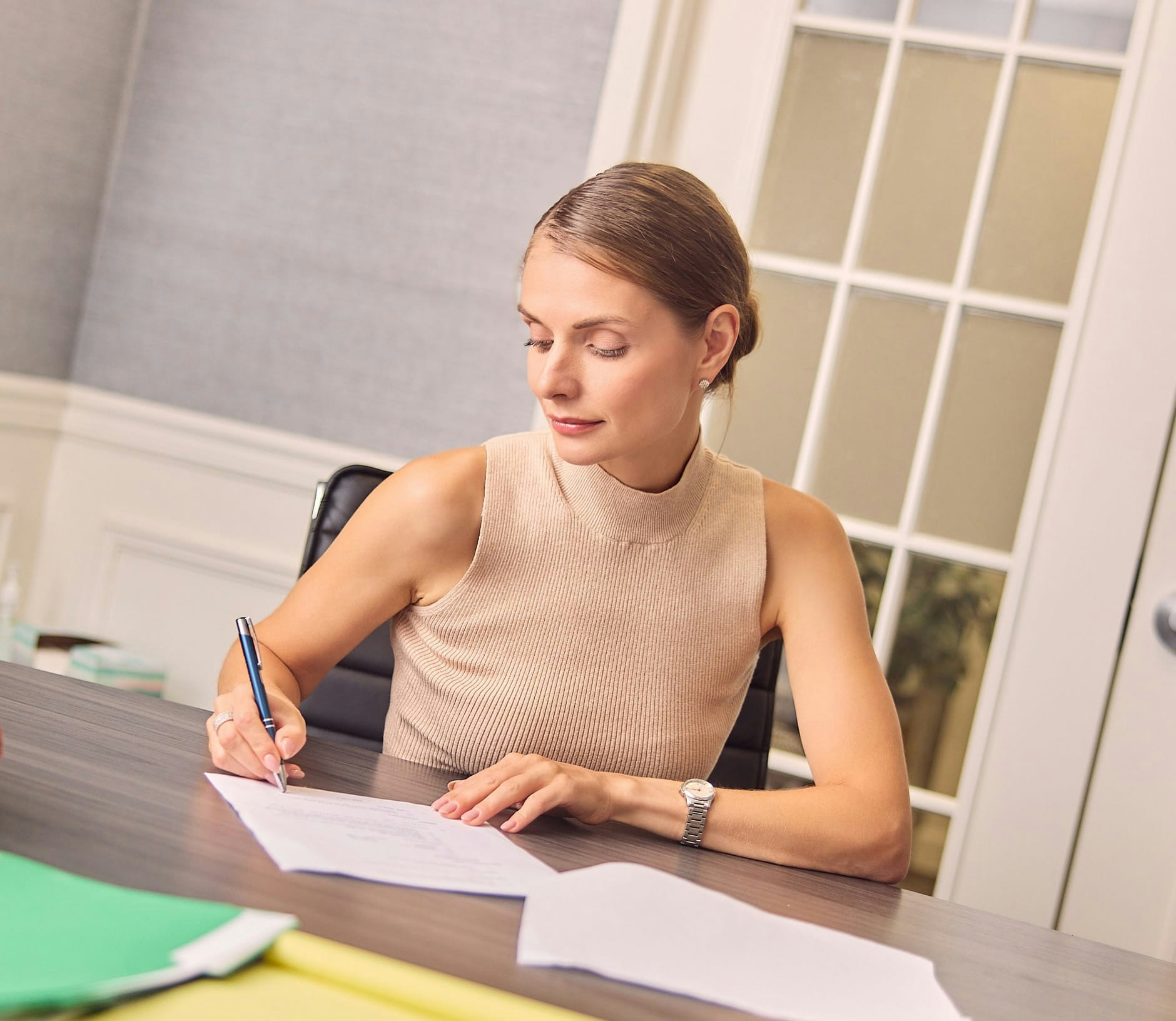 woman filling out form sitting at table