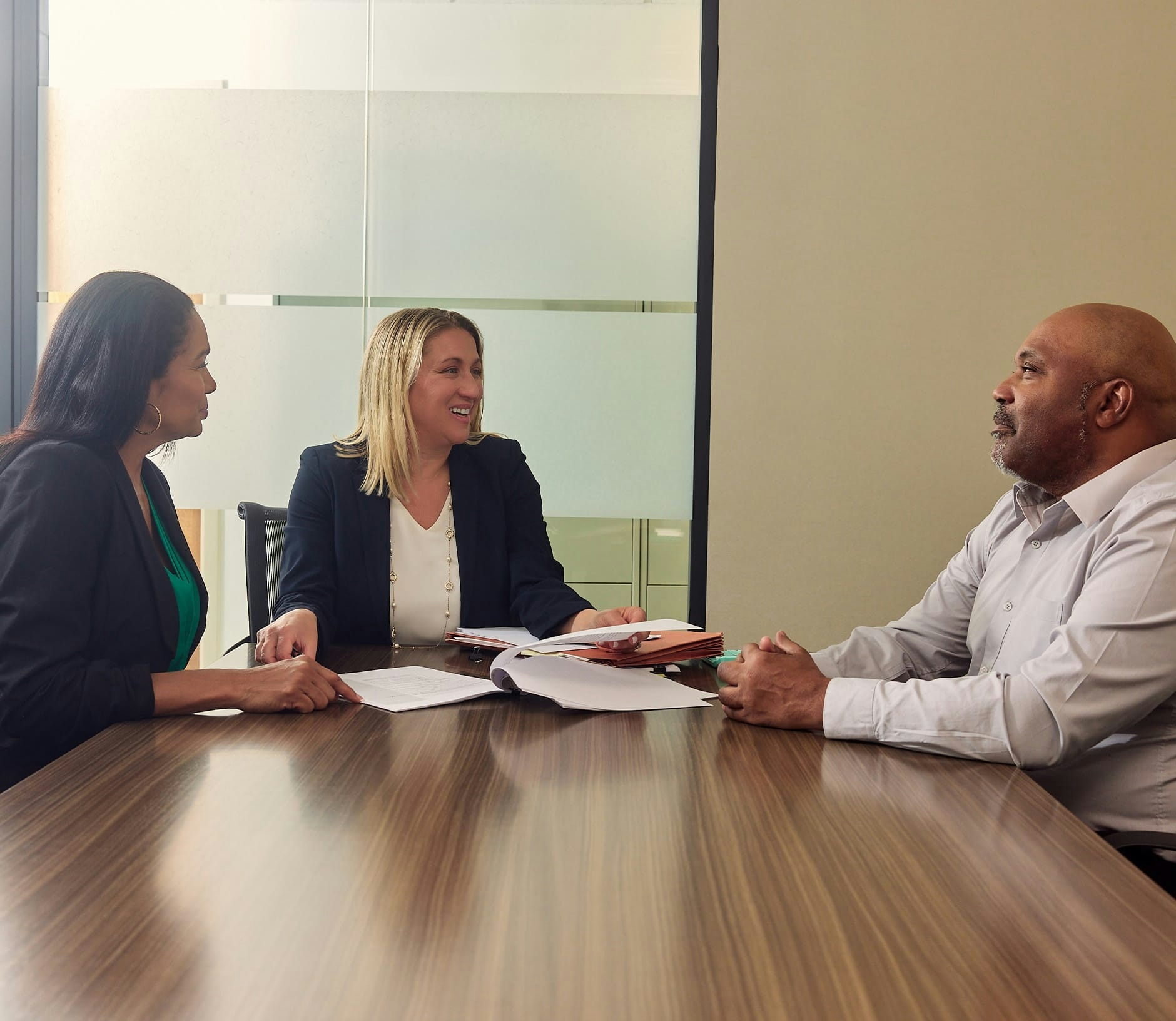 clients speaking to attorney at desk