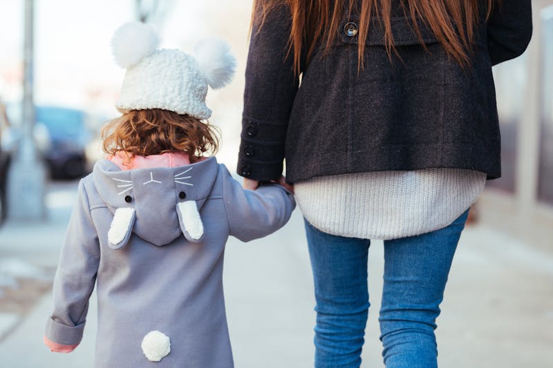 kid and mom holding hands