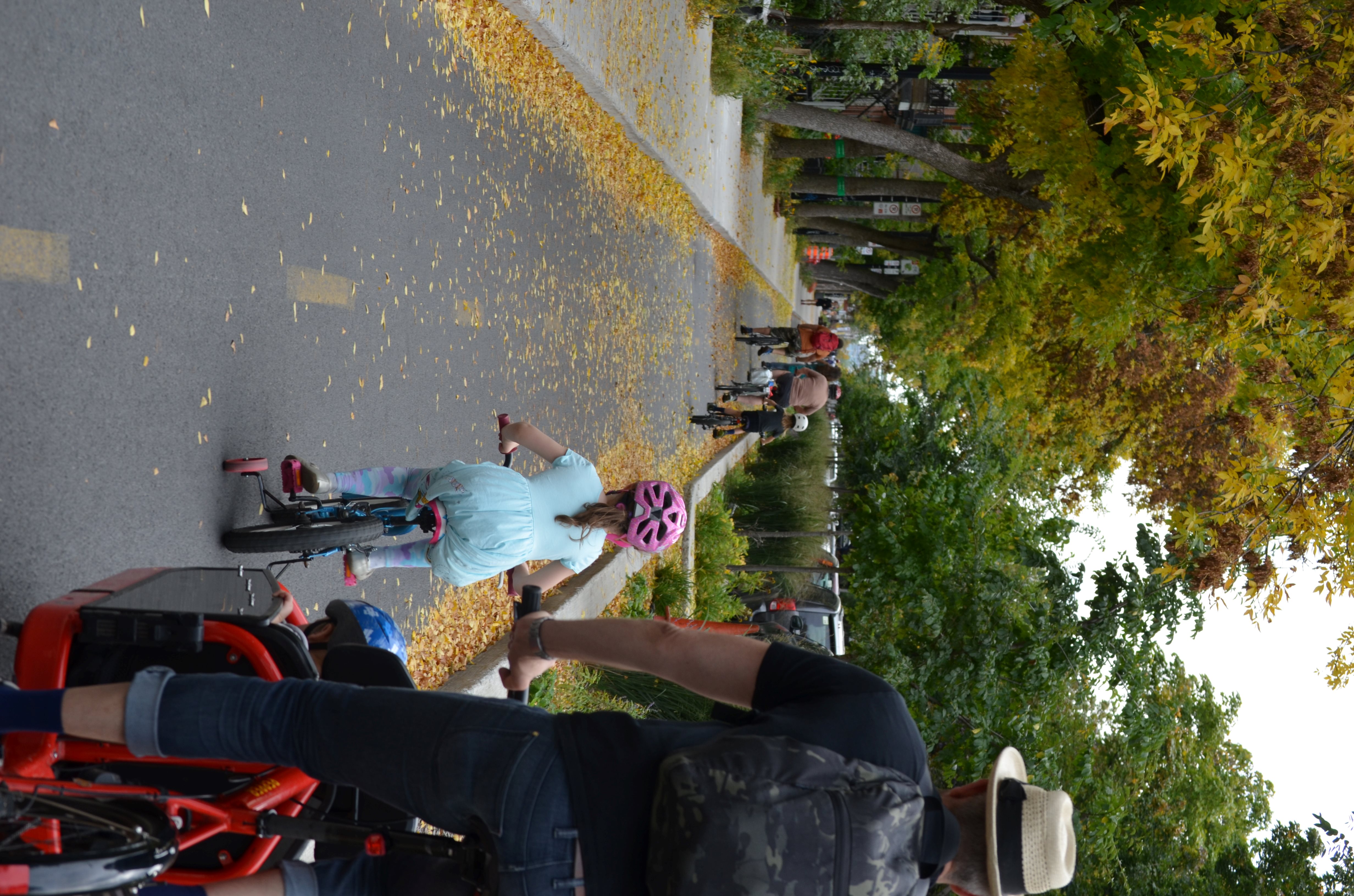 Family cycling on a cycle path separated from motorised traffic