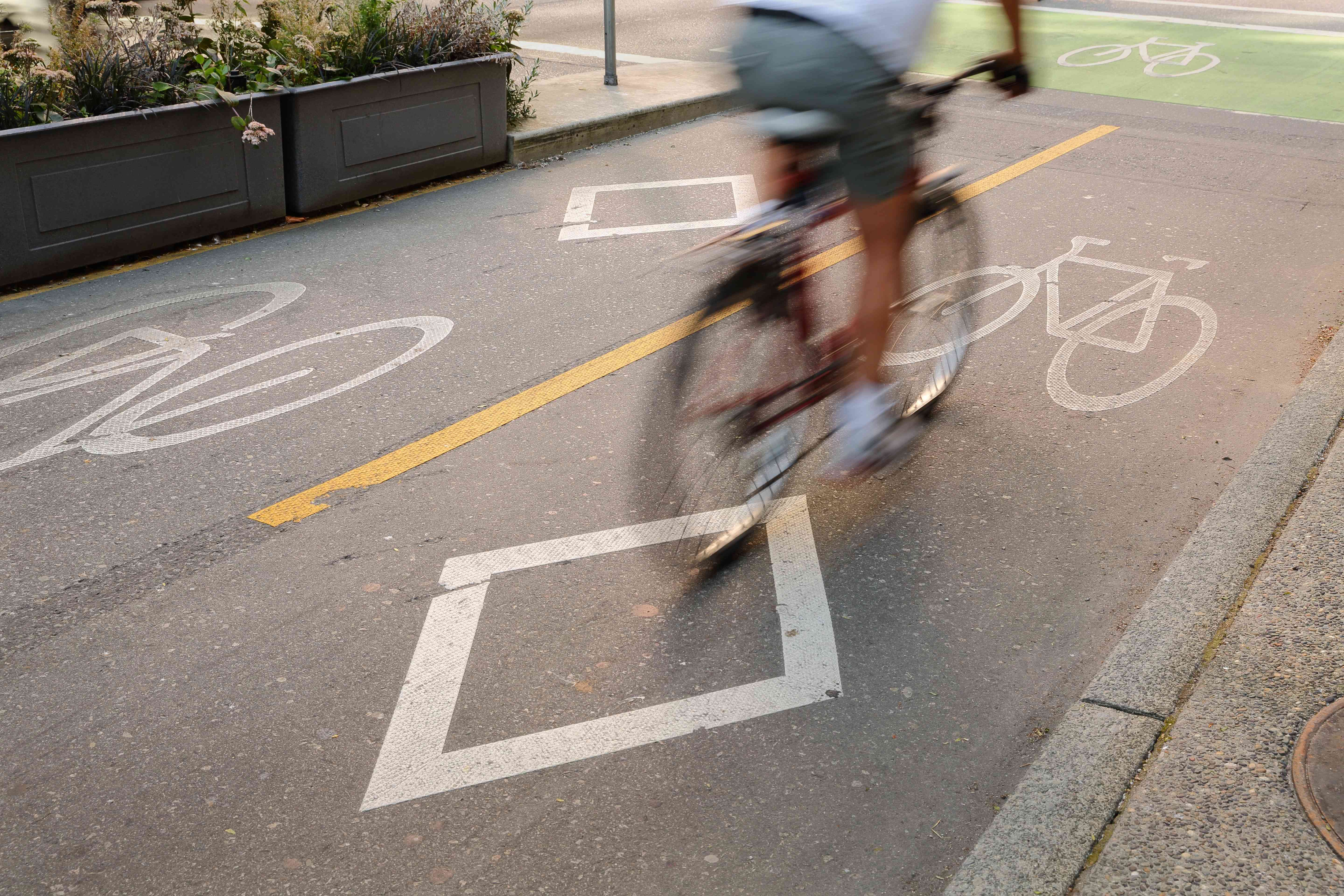 Cyclist on a two-way cycle lane protected from motorised traffic