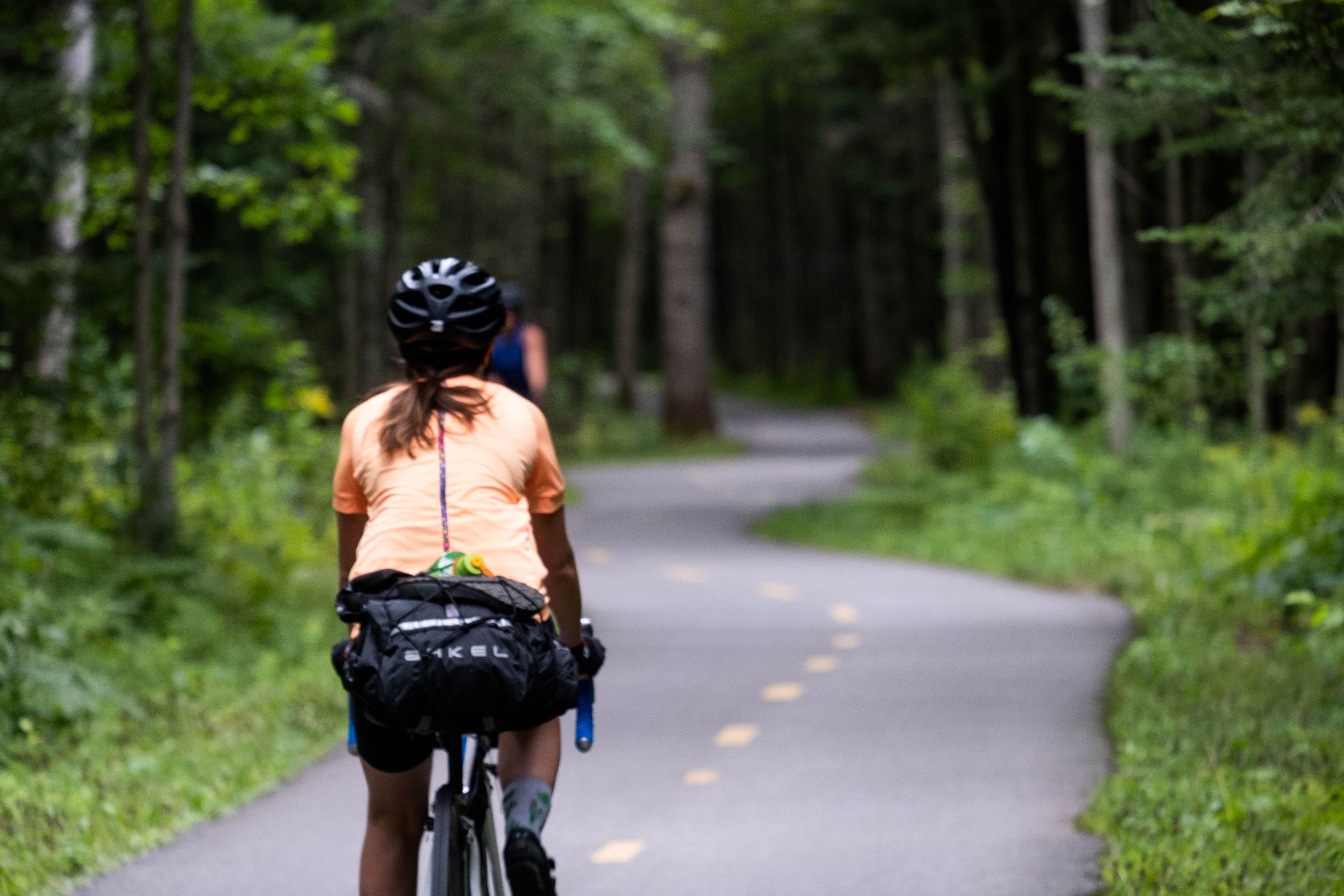 Two women cyclists on a cycle path in the woods