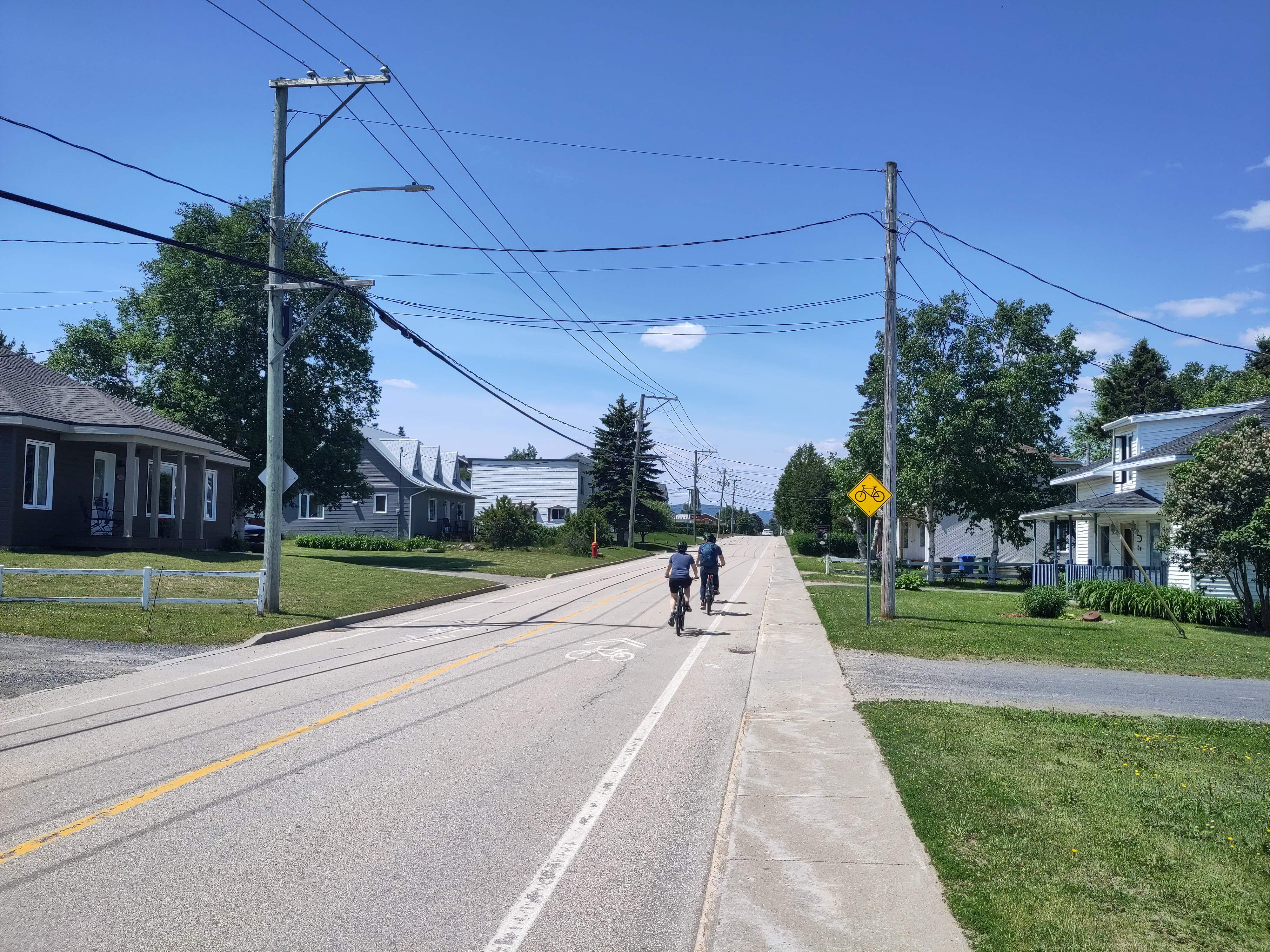 Group of cyclists travelling on a designated road in a suburban environment