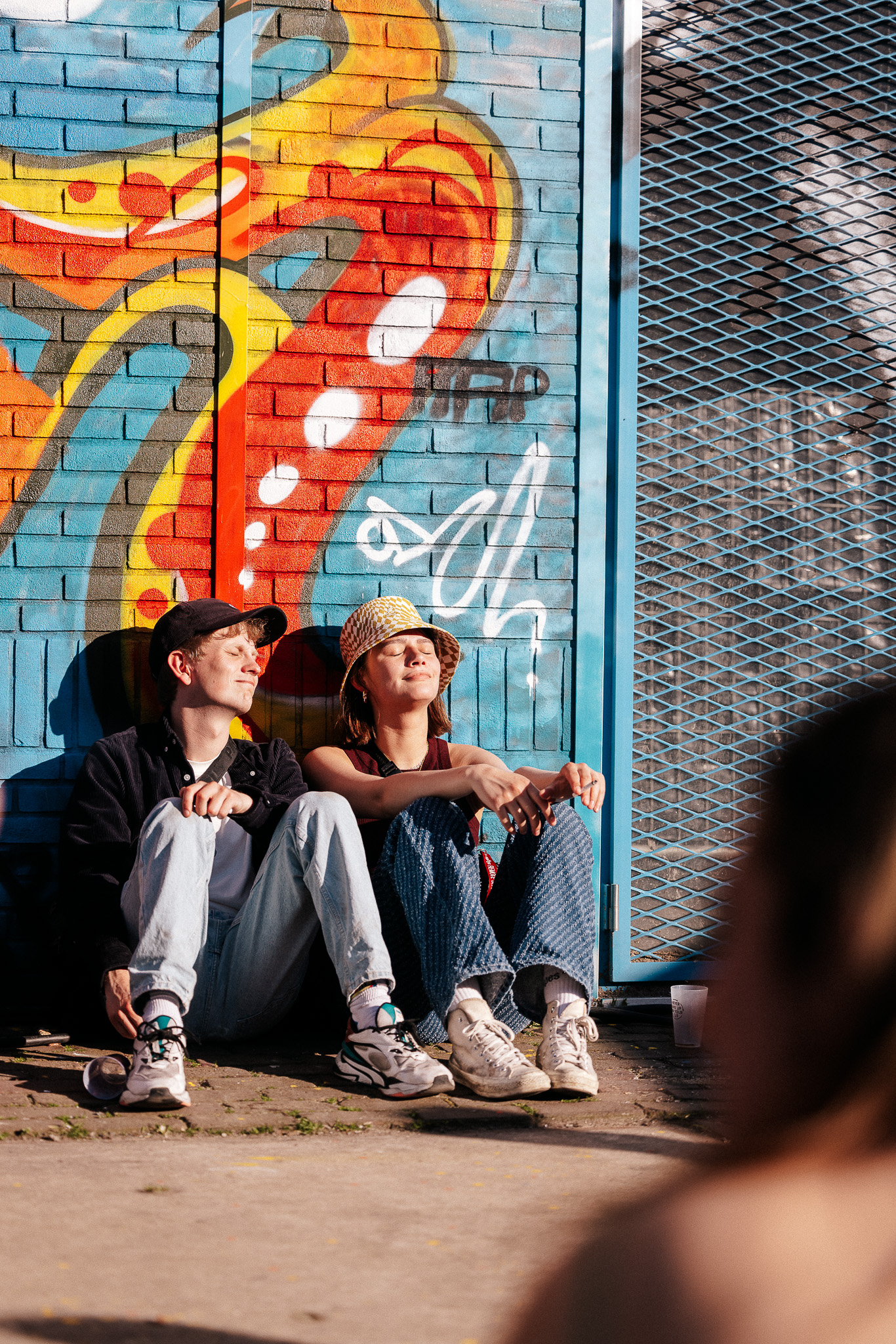 Visitors sitting in the sun at DGTL Amsterdam 2022