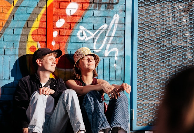 Visitors sitting in the sun at DGTL Amsterdam 2022