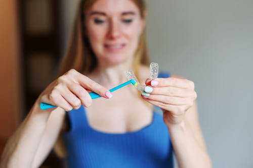 A girl with clear aligner- How to Clean Aligners Without Losing Your Mind (Or Your Smile)? | OrthoFX
