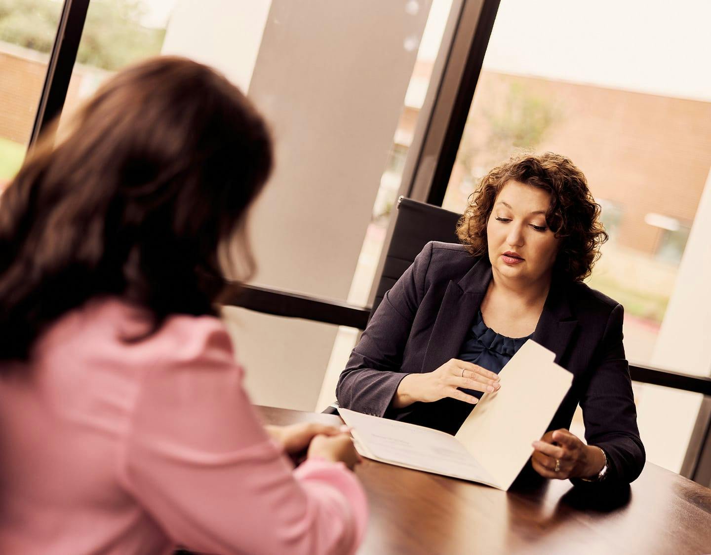 attorney showing paperwork to a woman