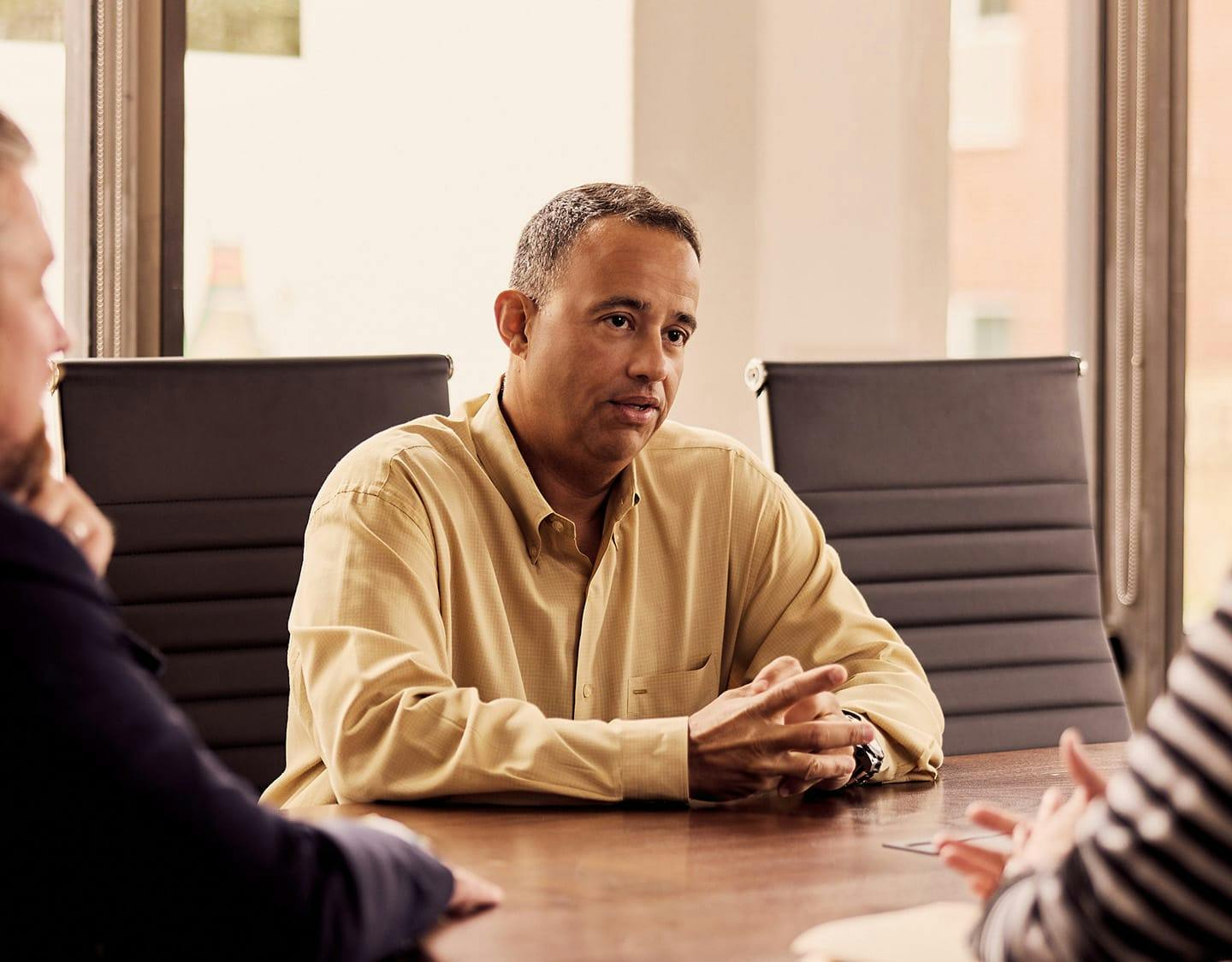 3 people talking around a table