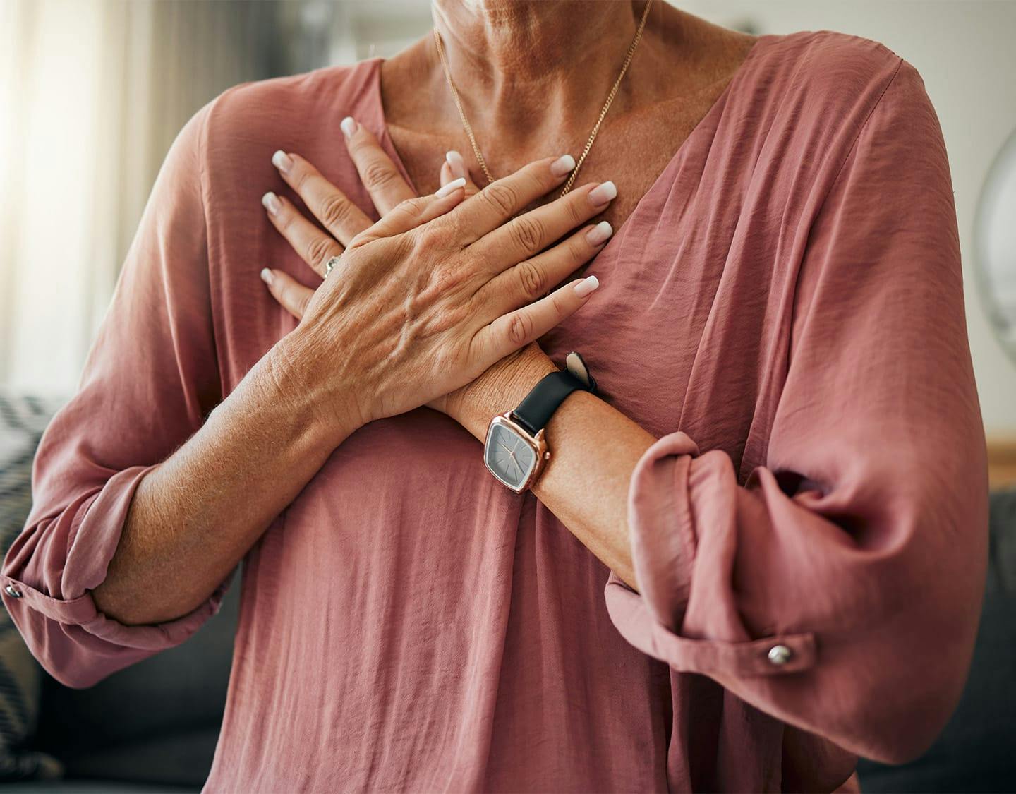 woman holding her chest
