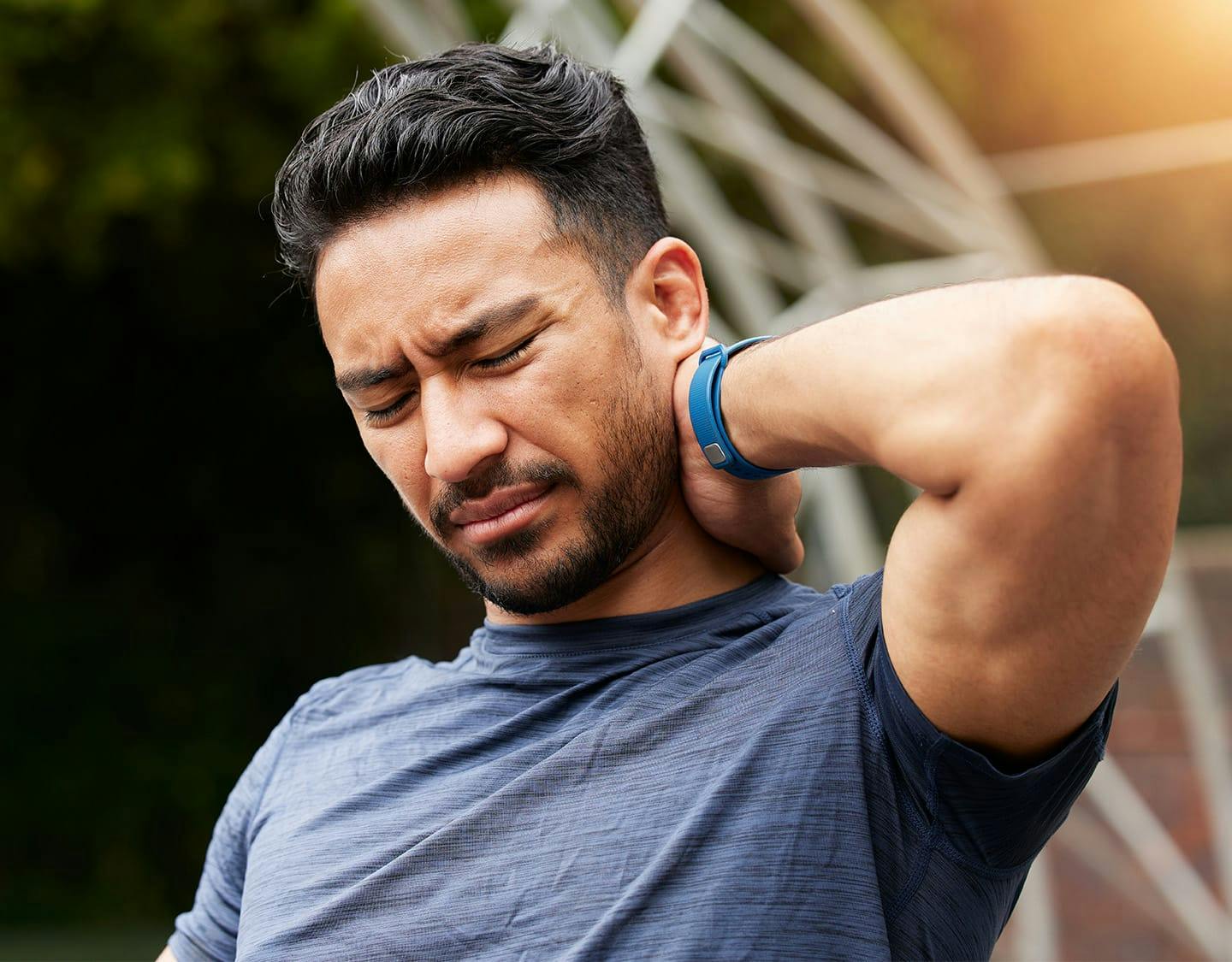 man holding his neck in pain