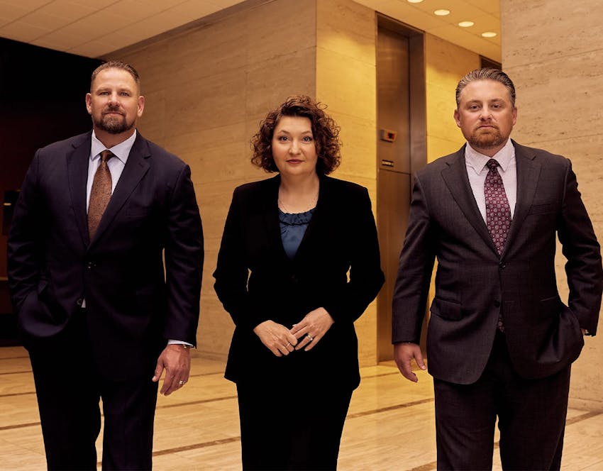 three attorneys standing together