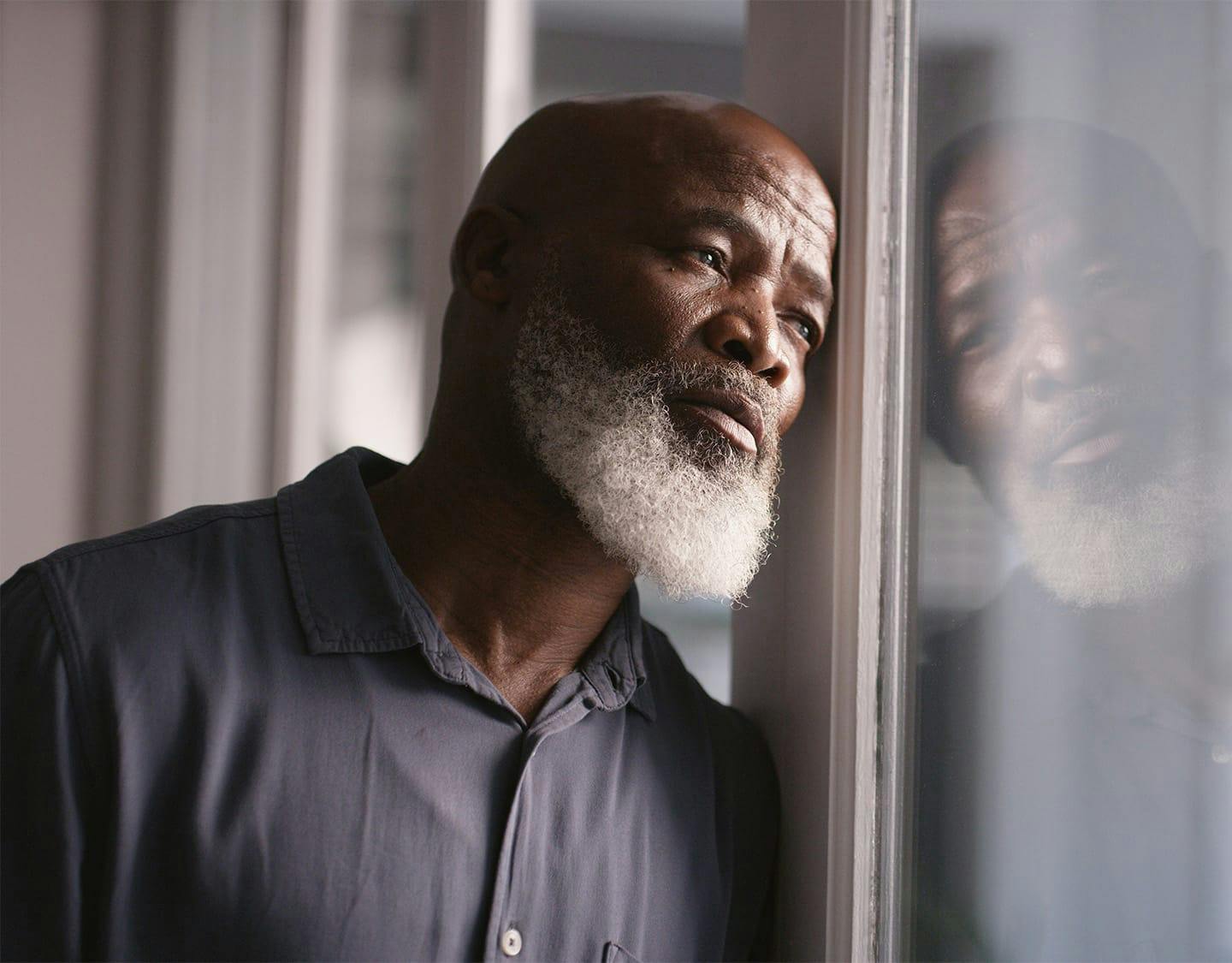 man leaning against a window
