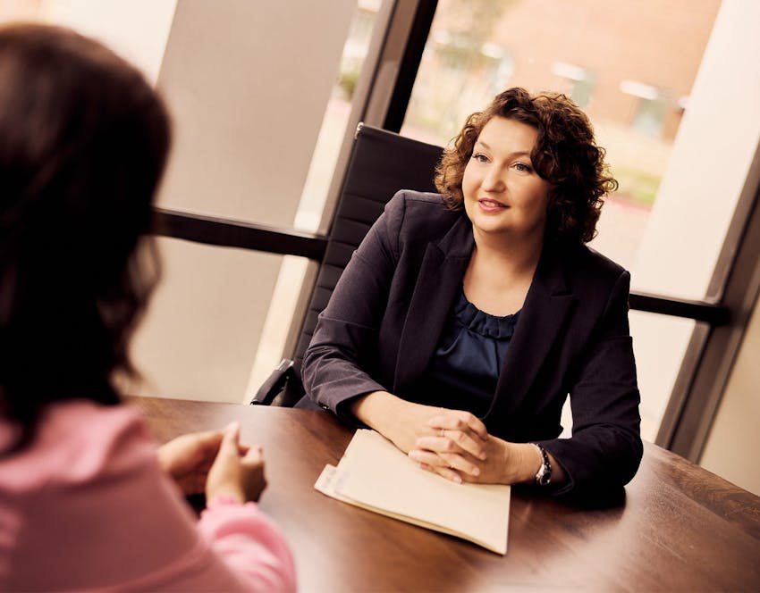 attorney and woman sitting at a table