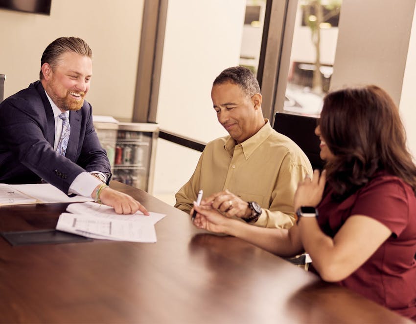 three people looking at paperwork