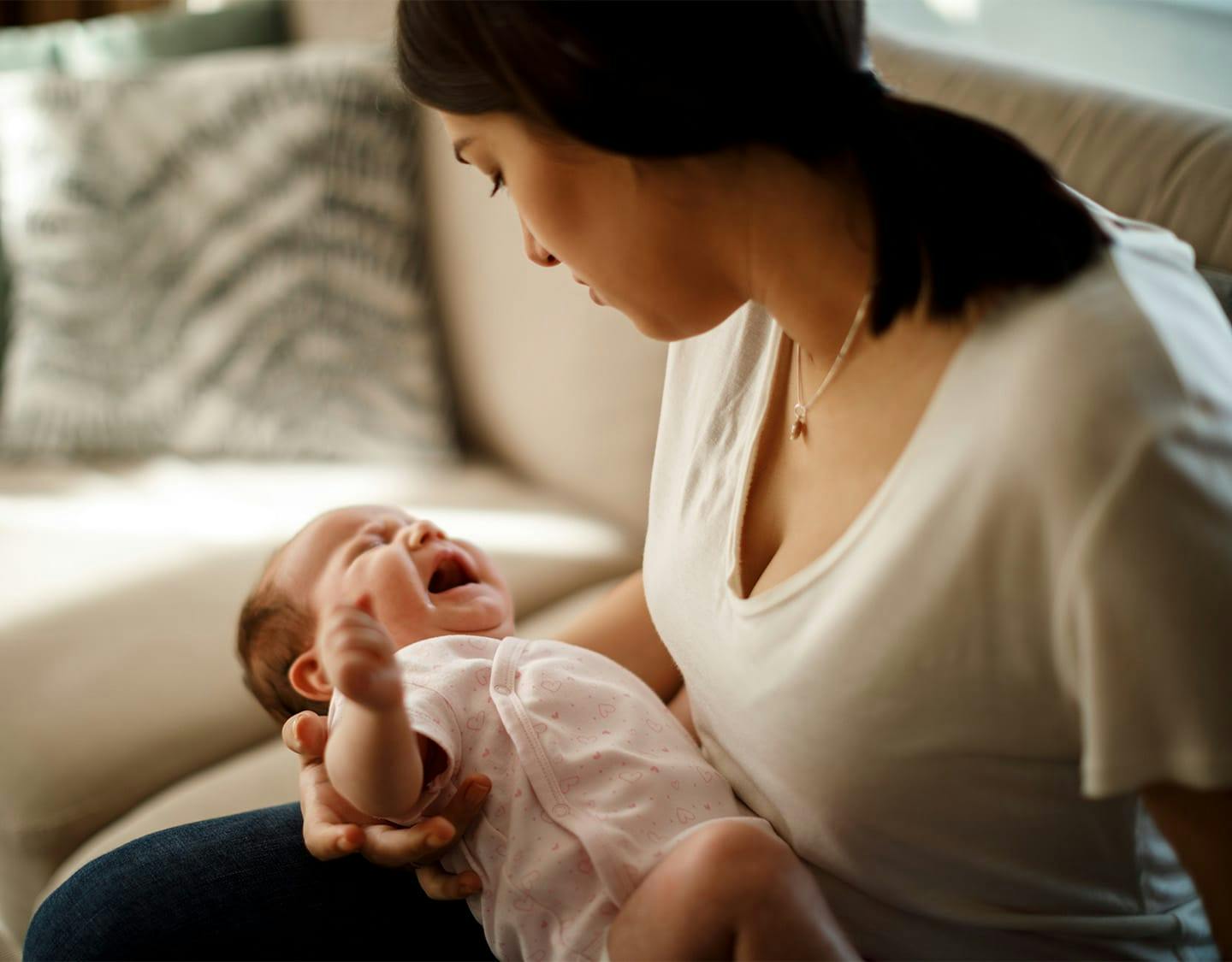 woman looking down at her baby