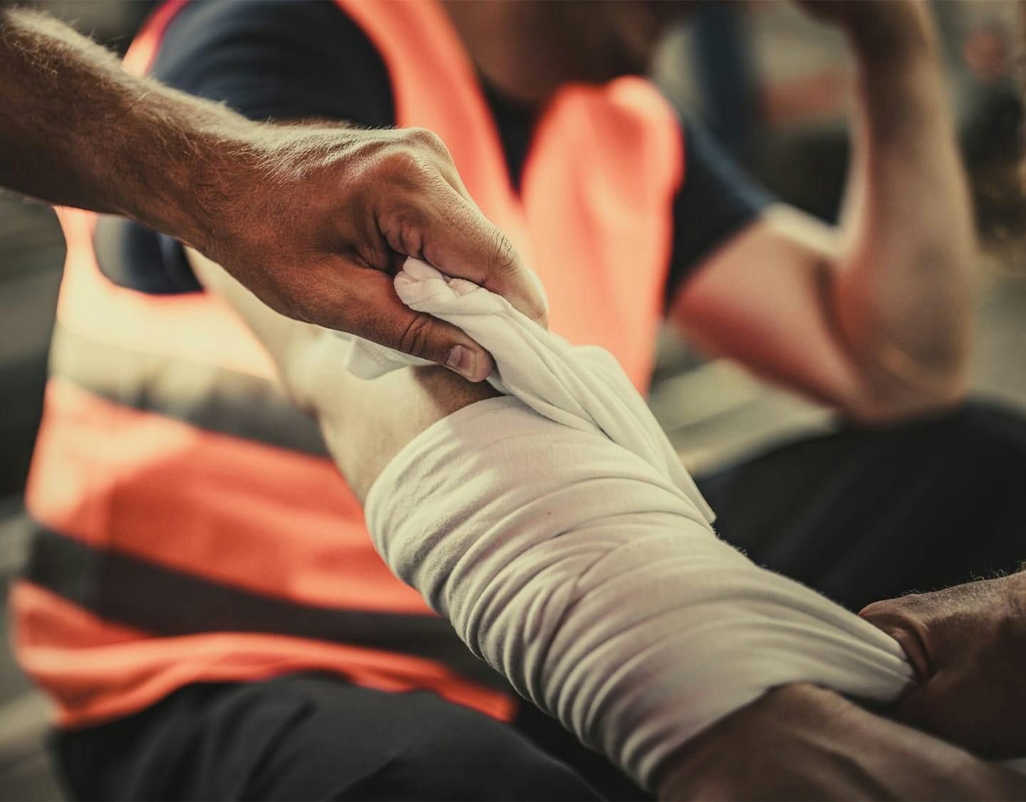 construction worker getting his arm wrapped