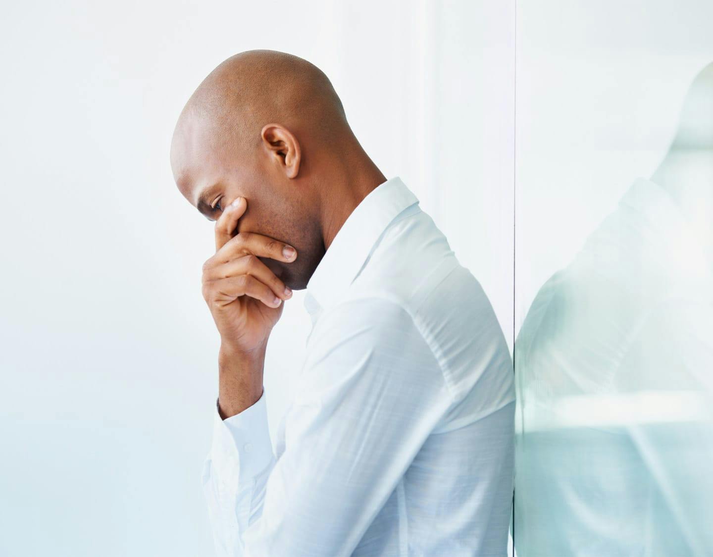man leaning against a wall
