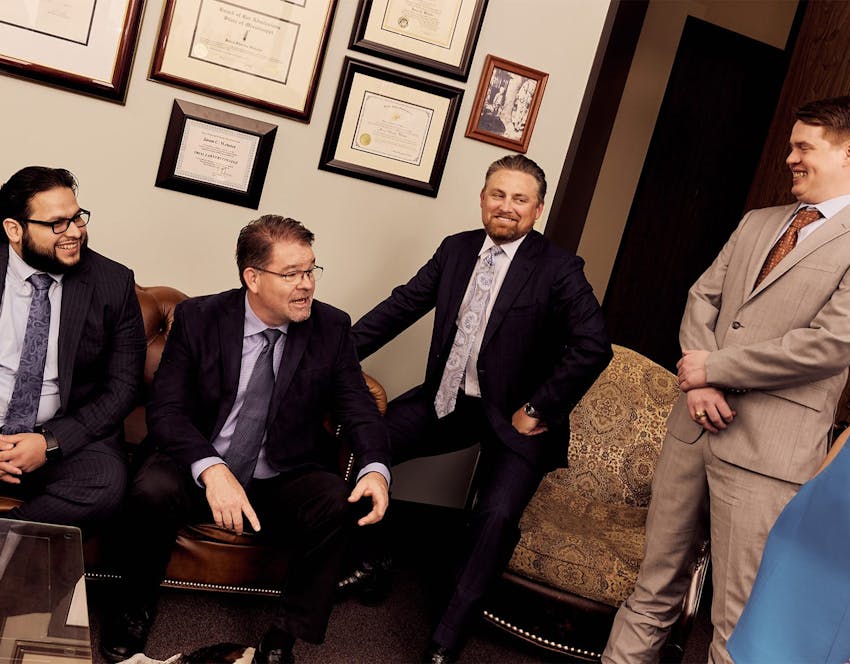 four attorneys sitting and chatting