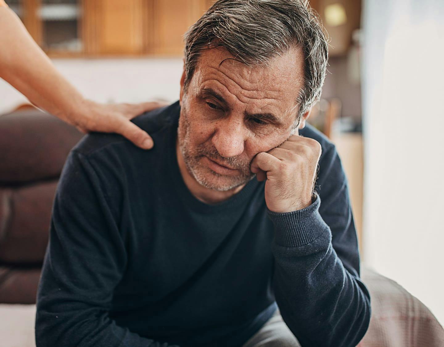older man leaning on his hand