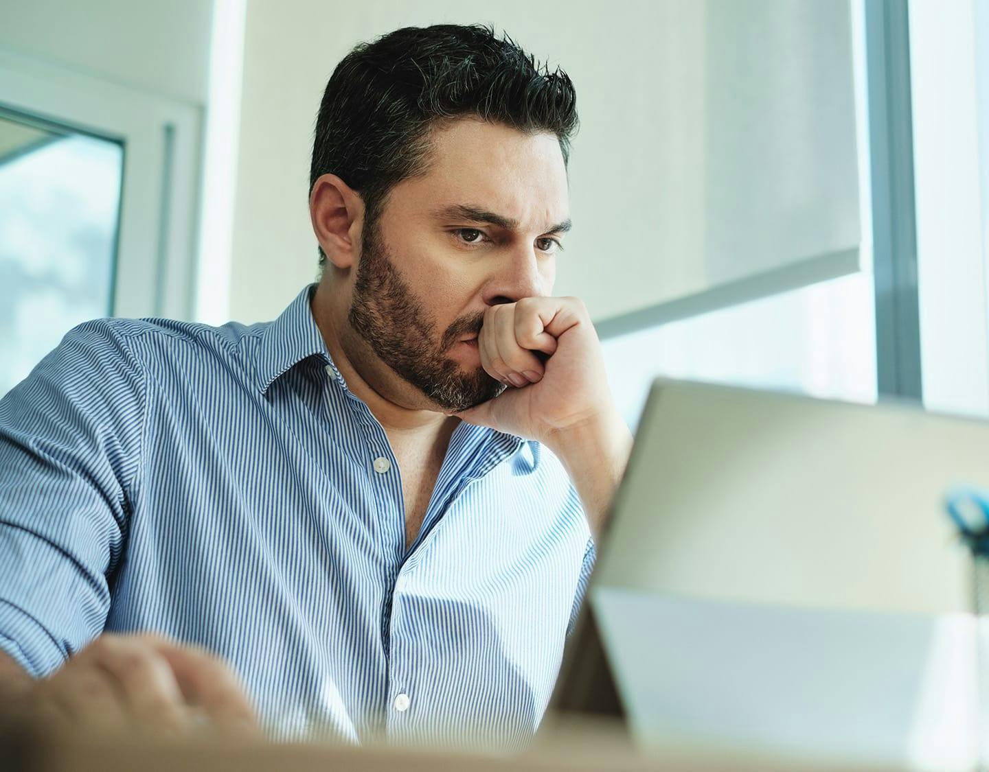 man looking at his tablet