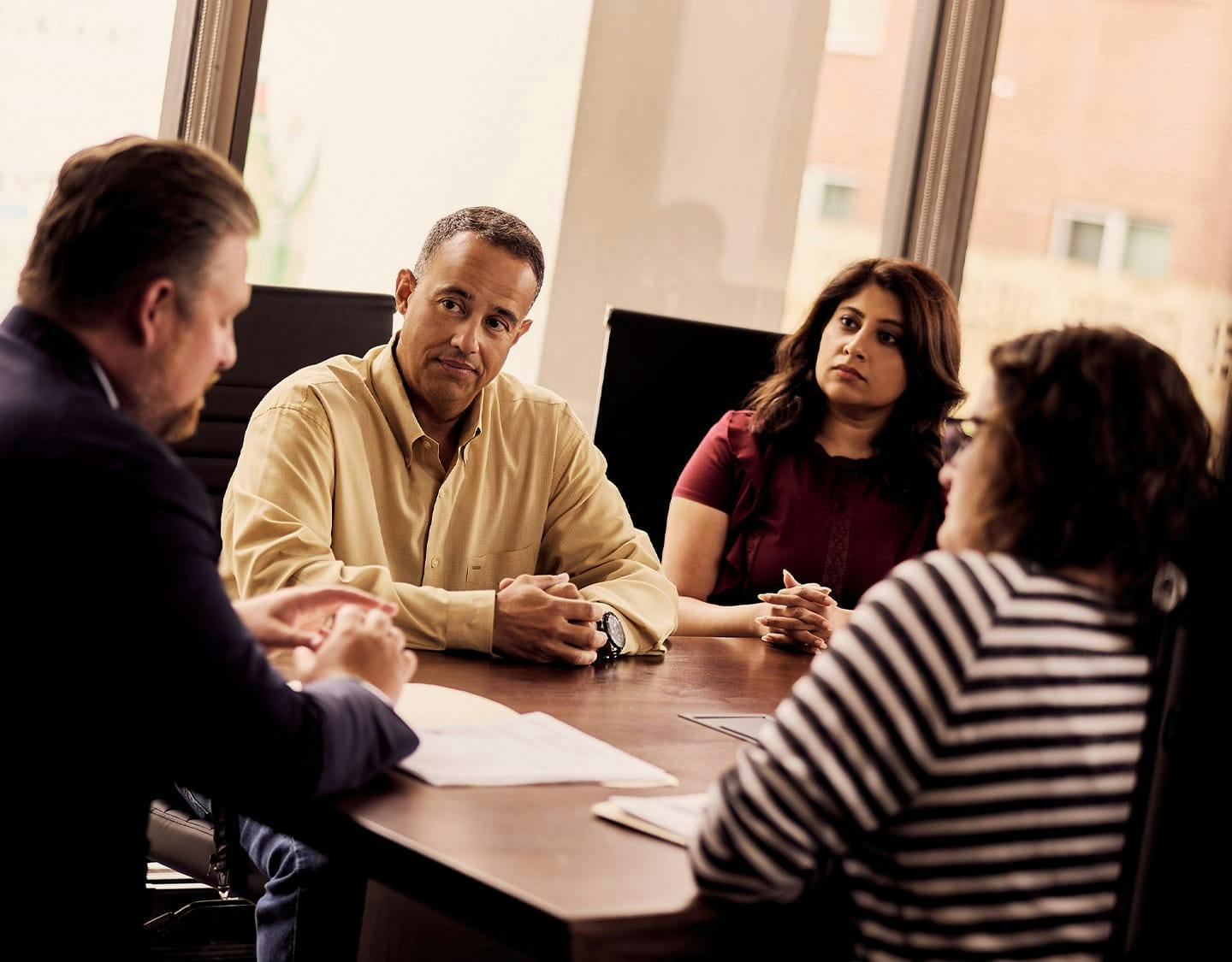 four people talking around a table