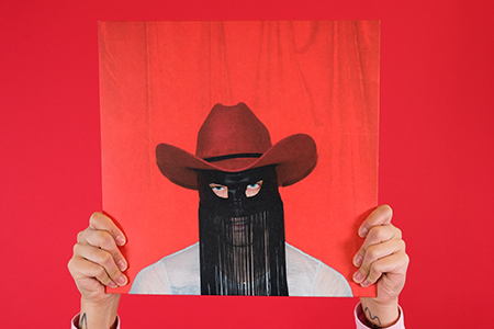 Hands holding Orville Peck - Pony vinyl record