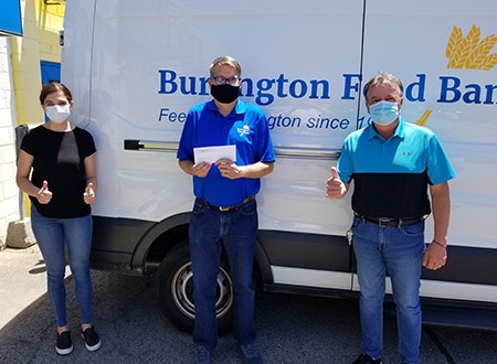 Ernie Addezi and Diandra Giannattasio handing a cheque to Burlington Food Bank leadership