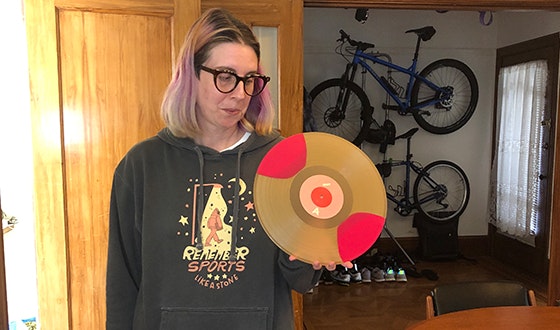 Jessie Frick holding a vinyl record