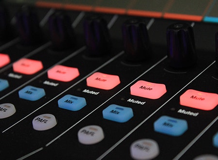 Mixing desk with illuminated control buttons