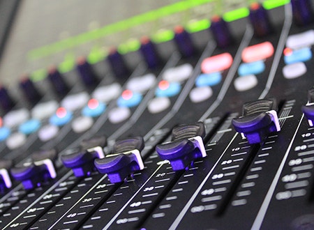 Motorized faders on a mixing desk