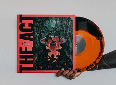 Hand holding vinyl record jacket and record